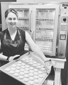 Rachel holding a tray of freshly baked cookies.